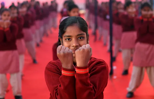 Indian school girls take part in a self-defence camp at a police training school in New Delhi on December 28, 2017. Over hundered women and children participated at the opening ceremony of the self-defence training winter camp being organised by the special police unit for women and children. (Photo by Money Sharma/AFP Photo)