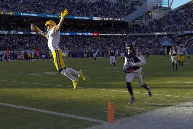 Green Bay Packers' Christian Watson reacts as he crosses the goal line after catching a touchdown pass during the second half of an NFL football game against the Chicago Bears Sunday, December 4, 2022, in Chicago. (Photo by Charles Rex Arbogast/AP Photo)