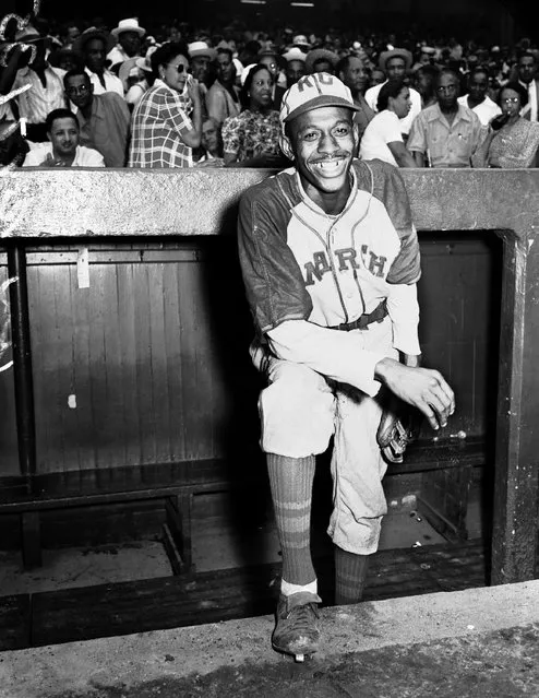 Kansas City Monarchs pitching great Leroy Satchel Paige poses in the dugout at New York's Yankee Stadium August 2, 1942 for a Negro League game between the Monarchs and the New York Cuban Stars.  Paige was considered a top prospect for the major leagues after baseball's commissioner ruled that there were no provisions barring players of color from the majors. (Photo by AP Photo)