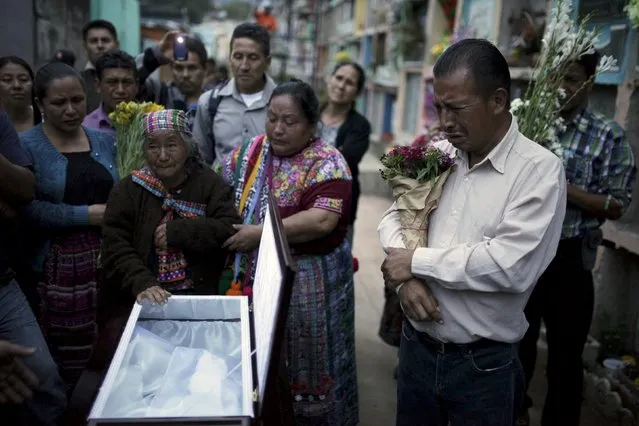 Relatives participate in the burial of Santos Etelvina Sontay, a victim of a mudslide in Santa Catarina Pinula, on the outskirts of Guatemala City, October 5, 2015. (Photo by Jose Cabezas/Reuters)
