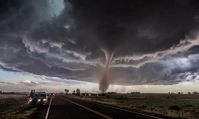 Overall winner: Tornado on show, Colorado by Tim Moxon. “A classic severe weather setup in the high plains of Colorado near the town of Wray yielded one of the most photogenic tornadoes of the year. We were just ahead of the storm as the tornado started and tracked with it as it grew from a fine funnel to a sizeable cone tornado. At this moment, the twister was at its most photogenic. We were among a number of people, including those you see in the shot, nervously enjoying the epic display nature put on for us”. (Photo by Tim Moxon/Weather Photographer of the Year 2016)