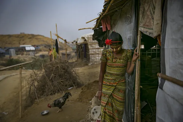 Rohingya refugees are seen in Balukhali camp on January 14, 2018 in Cox's Bazar, Bangladesh. Over 650,000 Rohingya have crossed the border to Bangladesh since August last year, fleeing the violence at Rakhine State when their villages were attacked and many worry that they will face further reprisals if they return to Myanmar. The refugee camps in Bangladesh no longer seem temporary as thousands of tents made of plastic and bamboo spread across the undulating terrain and long wooden bridges connect parts of the camps divided by water. Existing camps such as Nayapara and Kutupalong have swelled to accommodate the new arrivals since the Myanmar military began its campaign in late August while the Rohingya queue for hours to get rations due to little access to clean water, health care or food and the refugee camps turn into mud-baths whenever it rains. International aid groups and health workers have estimated at least 6,700 Rohingya had met with violent deaths and warn of potential outbreaks of cholera and other preventable diseases due to squalid conditions. (Photo by Allison Joyce/Getty Images)