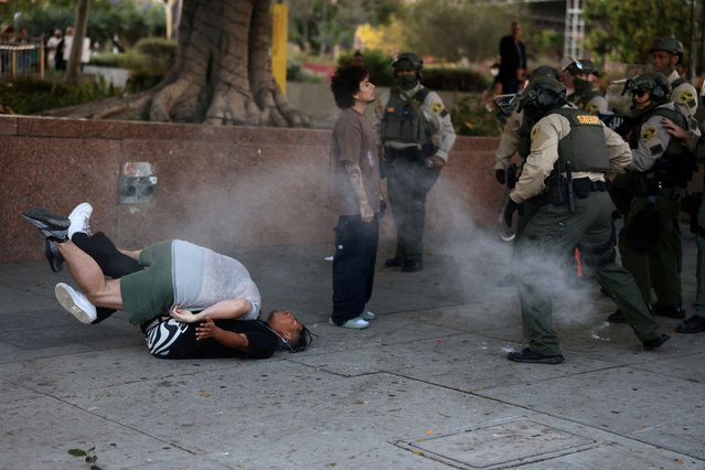 Law enforcement officers and protestors clash during a protest against federal immigration sweeps, in Los Angeles, California, U.S., June 11, 2025. (Photo by David Swanson/Reuters)