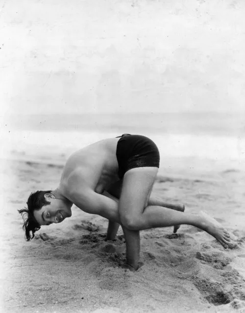 John Boles, the Hollywood actor, doing antics on the beach near his Malibu home, circa 1932. (Photo by Hulton Archive/Getty Images)