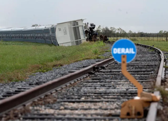 A train lies on the side of the tracks after it derailed after the passing of Hurricane Laura in Lake Charles, Louisiana on August 28, 2020. At least six people were killed by Hurricane Laura in Louisiana and search teams may find more victims, but the governor said on August 27 that the most powerful storm to make landfall in the US state in living memory did not cause the “catastrophic” damage that had been feared. (Photo by Andrew Caballero-Reynolds/AFP Photo)