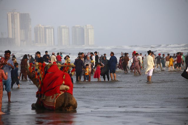 People cool off in the Arabian Sea during a heatwave in Karachi, Pakistan, 24 May 2025. (Photo by Shahzaib Akber/EPA/EFE)