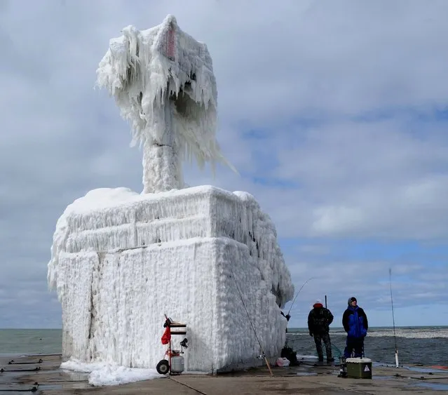Layers of ice coat a pier beacon as fishermen work the waters of Lake Michigan in St. Joseph, Michigan March 3, 2013. (Photo by Don Campbell/The Herald-Palladium)
