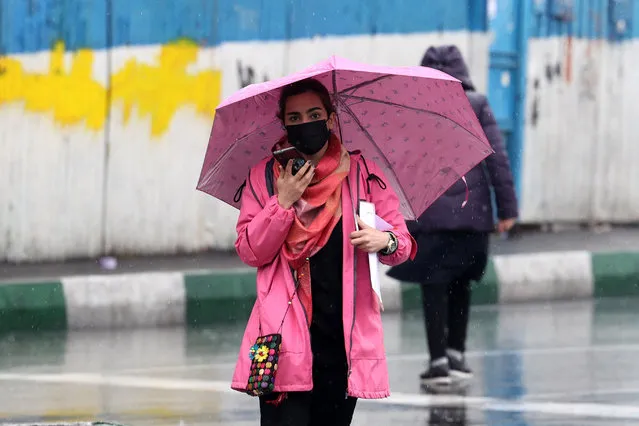 An Iranian woman walks in the street on a rainy day in the capital Tehran, on December 4, 2022. Iran has scrapped its morality police after more than two months of protests triggered by the death of Mahsa Amini following her arrest for allegedly violating the country's strict female dress code, local media said Sunday.women (Photo by Atta Kenare/AFP Photo)