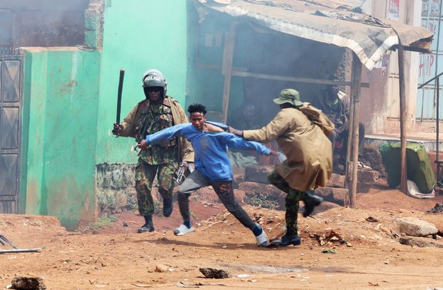 A riot police officer gets hold of a protester during an anti-government protest labelled the Saba Saba people’s march in Nairobi, Kenya on July 7, 2025 to commemorate 7 July 1990, when Kenyans rose up to demand a return to multi-party democracy after years of autocratic rule by the then president, Daniel arap Moi. (Photo by Monicah Mwangi/Reuters)