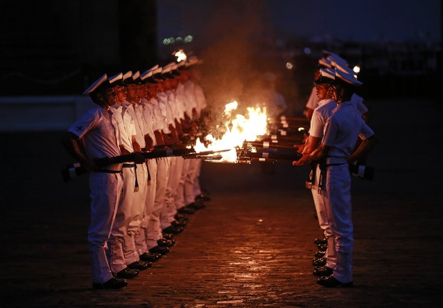 Indian Navy soldiers demonstrate their skills during Navy Day celebrations in Mumbai December 2, 2014. The Indian Navy celebrates Navy Day to commemorate its action at Karachi Harbour during the India-Pakistan war in 1971. (Photo by Danish Siddiqui/Reuters)