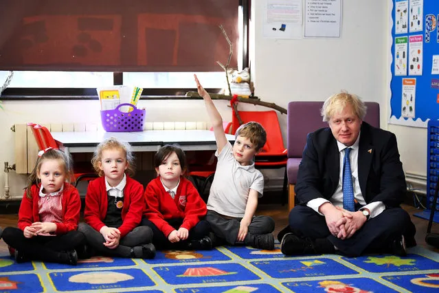 Britain's Foreign Secretary Boris Johnson sits with Year 1 pupils from the Stingray class during a visit to St Leonard's Church of England Primary Academy in Hastings, Britain, March 8, 2018. (Photo by Dylan Martinez/Reuters)