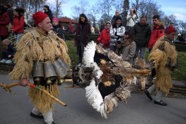 Costumed people, mask dancers called Kukeri, perform a traditional dance during the Surva Festival to ward off evil spirits in Sofia, Bulgaria, 09 January 2022. In ancient times, the old Thracians held the Kukeri Ritual Games in honor of god Dionysus - known as a god of wine and ecstasy. Even today these games are also known as the Dionysus' games. Among the Kukeri (singular: kuker) dancers' are many characters, including Dionysus and his satyrs as well as others from deep history such as the tsar, harachari, plyuvkachi, startzi, and pesyatzi. (Photo by Vassil Donev/EPA/EFE)