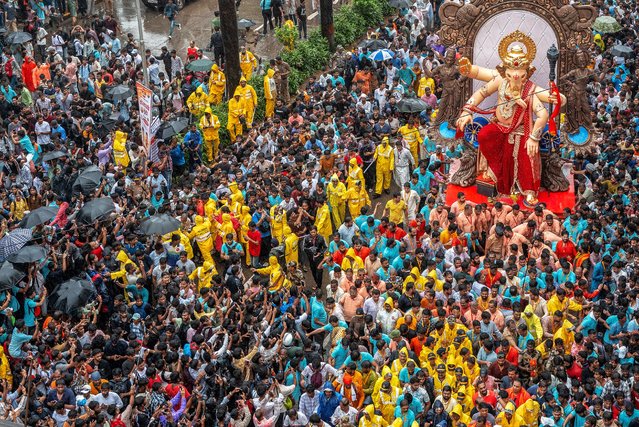 Devotees carry an idol of the elephant-headed Hindu deity “Ganesha” during a procession in Mumbai on August 17, 2025, ahead of the Ganesh Chaturthi festival. (Photo by Punit Paranjpe/AFP Photo)