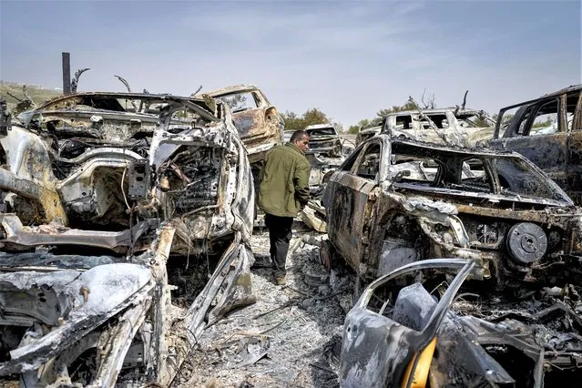 A Palestinian man walks between scorched cars in a scrapyard, in the town of Hawara, near the West Bank city of Nablus, Monday, February 27, 2023. Scores of Israeli settlers went on a violent rampage in the northern West Bank, setting cars and homes on fire after two settlers were killed by a Palestinian gunman. Palestinian officials say one man was killed and four others were badly wounded. (Photo by Ohad Zwigenberg/AP Photo)