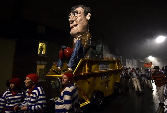 An effigy of British television presenter and former host of the 'Top Gear' programme, Jeremy Clarkson, is paraded through the streets before being set alight during Bonfire night celebrations in Lewes, southern England November 5, 2015. The processions and bonfire mark the uncovering of Guy Fawkes' "Gunpowder Plot" to blow up the Houses of Parliament in 1605, and commemorates the memory of Lewes' seventeen Protestant martyrs. (Photo by Toby Melville/Reuters)