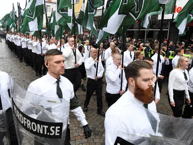 Members of the Neo-nazi Nordic Resistance Movement march through the town of Ludvika, Sweden on May 1, 2018. The march was opposed by anti-fascist groups and the local police, reinforced from other parts of Sweden, kept the groups apart. (Photo by Ulf Palm/Reuters/TT News Agency)