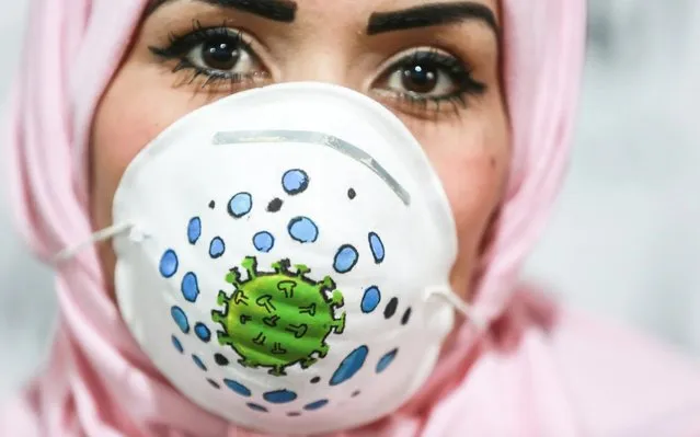 Gazan artist wears a face mask to raise awareness to the novel coronavirus (Covid-19) spread in Gaza Strip on March 25, 2020. (Photo by Ali Jadallah/Anadolu Agency via Getty Images)