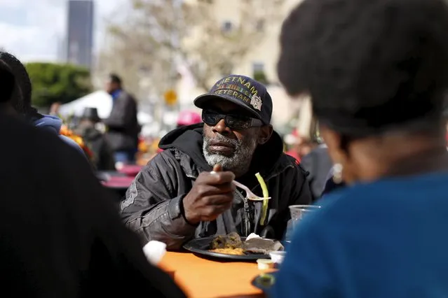 A man eats an early Thanksgiving meal served to the homeless at the Los Angeles Mission in Los Angeles, California, November 25, 2015. (Photo by Mario Anzuoni/Reuters)