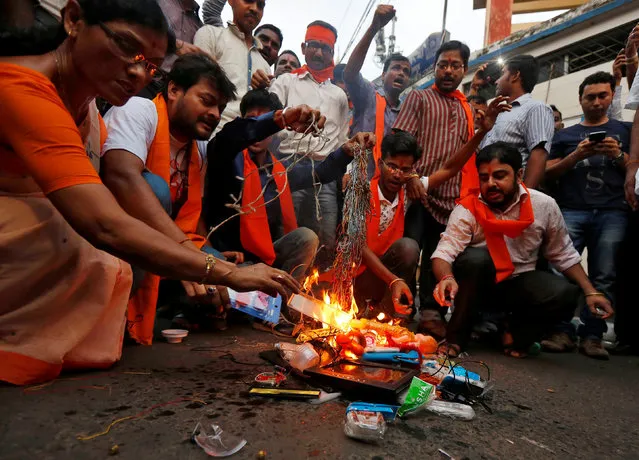 Demonstrators burn Chinese goods during a rally organised by the activists of Bajrang Dal, a Hindu hardline group, as they demand the boycott of Chinese products, in Kolkata, India, October 25, 2016. (Photo by Rupak De Chowdhuri/Reuters)