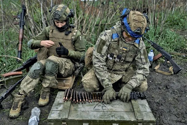 Ukrainian soldiers prepare their ammunition at the frontline positions near Vuhledar, Donetsk region, Ukraine, Monday, May 1, 2023. (Photo by Libkos/AP Photo)