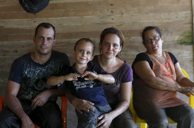A Cuban family poses for a photograph after they crossed the border from Colombia through the jungle into La Miel, in the province of Guna Yala, Panama December 2, 2015. (Photo by Carlos Jasso/Reuters)