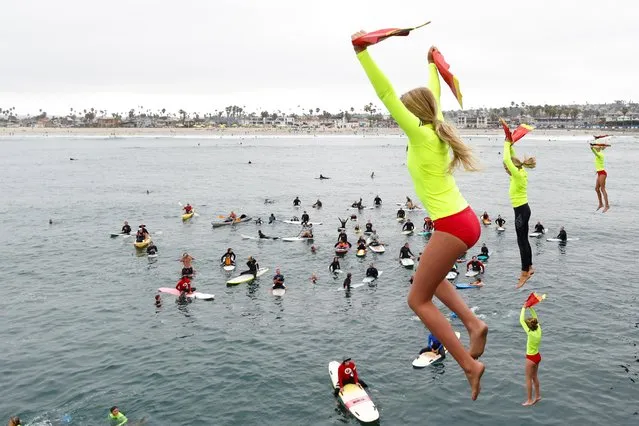 Participants of the City of San Diego Junior Lifeguard Program jump from the pier in an annual rite of passage during the outbreak of coronavirus disease (COVID-19) in Ocean Beach, California, U.S., August 10, 2020. (Photo by Mike Blake/Reuters)