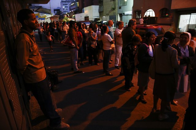 People line up to buy toilet paper at a supermarket in downtown Caracas January 19, 2015. (Photo by Jorge Silva/Reuters)