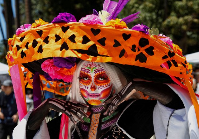 A participant dressed as the popular Mexican figure “Catrina” performs during the Day of the Dead celebrations in Vina del Mar, Chile on November 2, 2024. (Photo by Rodrigo Garrido/Reuters)