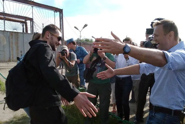 Russian opposition leader Aleksei Navalny (right) greets his brother Oleg Navalny (left) after he was released after spending 3 1/2 years in prison in the western Oryol region on June 29, 2018. In 2014, the two brothers were convicted of stealing about $500,000 from two Russian firms and of laundering some of the money. Both were sentenced to 3 1/2 years, but Aleksei's sentence was suspended. The European Court of Human Rights has ruled that the brothers were convicted unfairly. (Photo by Anastasia Bogdashova/TASS)