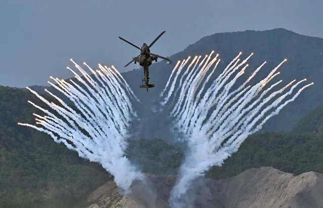 A South Korean Apache AH-64 helicopter fires flares during a joint South Korea-US military drill at the Seungjin Fire Training Field in Pocheon, South Korea, 15 June 2023. The Combined Joint Live-Fire Exercise, the first of its kind in six years, was held to mark the 70th anniversary of the South Korea-U.S. alliance and the 75th anniversary of the founding of South Korea's armed forces. (Photo by Jung Yeon-Je/Pool via EPA)