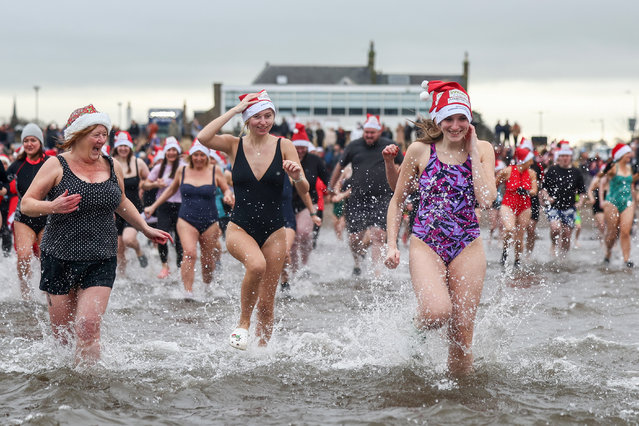 Revellers take part in a boxing day dip on December 26, 2024 in Ayr, Scotland. The event is a charity swim that raises funds for Ayrshire Cancer Support, which provides free services to people in Ayrshire affected by cancer. (Photo by Jeff J. Mitchell/Getty Images)