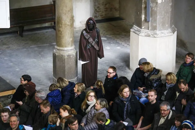A person, center top, dressed as the  “Star Wars Jawa” character  attends  a Star Wars themed church service, at the  Zion Church in Berlin, Sunday, December 20, 2015. (Photo by Markus Schreiber/AP Photo)
