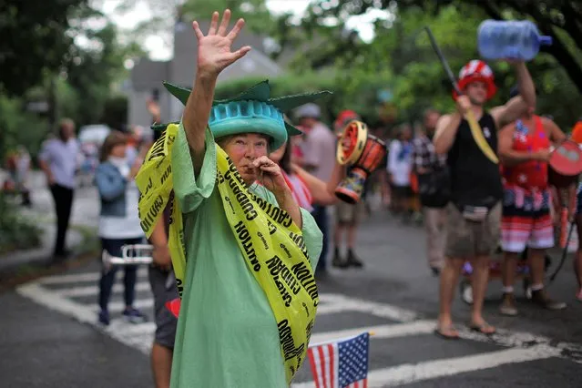 Local residents, including a woman dressed as the Statue of Liberty wrapped in caution tape, hold their own Fourth of July Parade in the Lanesville neighborhood of Gloucester, Massachusetts, U.S., July 4, 2023. (Photo by Brian Snyder/Reuters)