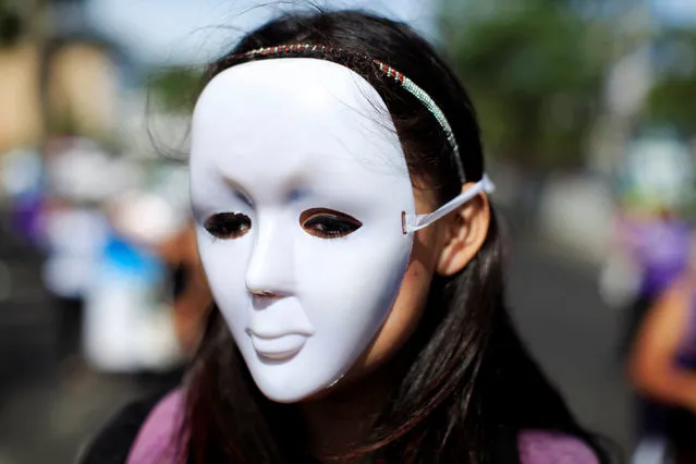 A woman wears a mask as she participates in a demonstration to commemorate the U.N. International Day for the Elimination of Violence against Women in San Salvador, El Salvador November 25, 2016. (Photo by Jose Cabezas/Reuters)