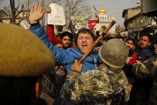 A Kashmiri Shiite Muslim shouts slogans as police stop them during a protest against Saudi Arabia in Srinagar, Indian controlled Kashmir, Sunday, January 3, 2016. Indian police used tear smoke and rubber bullets to disperse Shiite Muslims who were protesting after Saudi Arabia announced the execution of Shiite cleric Sheikh Nimr al-Nimr on Saturday along with 46 others, including three other Shiite dissidents and a number of al-Qaida militants. (Photo by Mukhtar Khan/AP Photo)