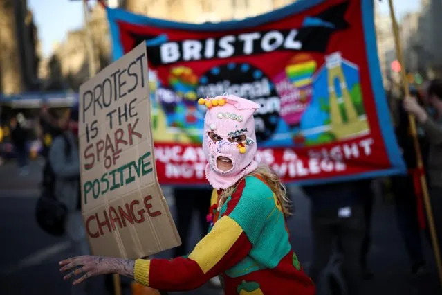 A masked demonstrator holds a placard during a “Kill the Bill” protest in Bristol, Britain, April 3, 2021. (Photo by Henry Nicholls/Reuters)