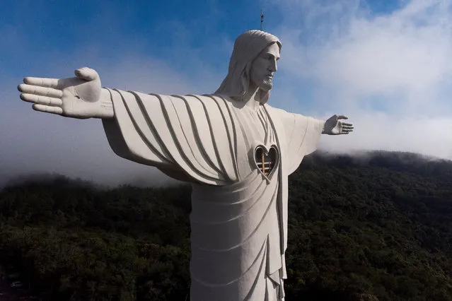 Aerial view of the statue of Christ the Protector in Encantado, state of Rio Grande do Sul, Brazil, on May 20, 2022. The new 143-foot statue is larger than Christ the Redeemer in Rio de Janeiro and the third largest in the world. It will open to visitors in 2023. (Photo by Silvio Avila/AFP Photo)