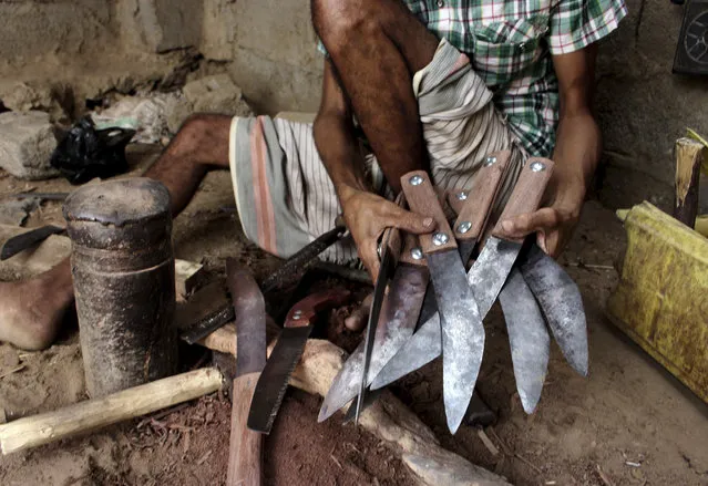 In this August 4, 2018, photo, a craftsman makes daggers or “Jambiyya” in Yemeni Arabic, made out of remains of missiles, at his workshop, in Hajjah, Yemen. (Photo by Hammadi Issa/AP Photo)