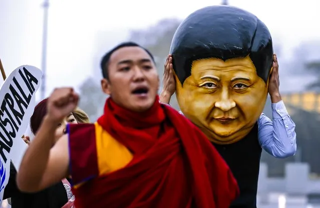 A protester wearing a giant head representing China's President Xi Jinping takes part in a demonstration calling Xi out for rights violations in Tibet in front of the European headquarters of the United Nations in Geneva, on Oktober 22, 2013. The 17th session of the Human Rights Council's Universal Periodic Review Working Group will be held in Geneva from until  November 1 during which 15 states are scheduled to have their human rights records examined under this mechanism. China's review on its human rights situation is scheduled for Tuesday. (Photo by Denis Balibouse/Reuters)