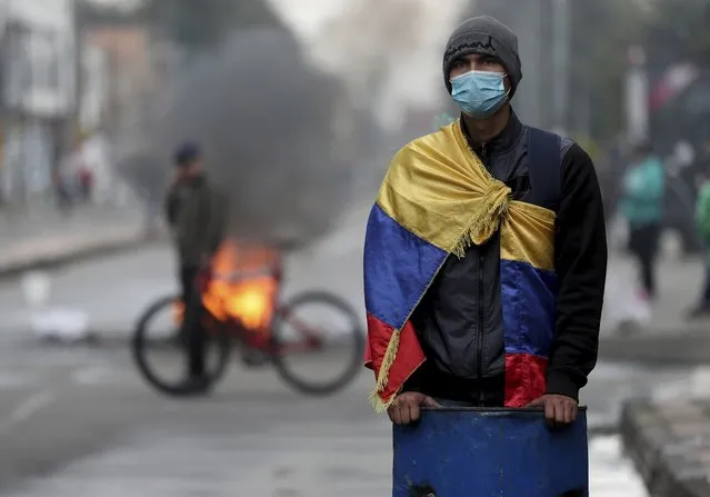 A demonstrator takes part in an anti-government protest triggered by proposed tax increases on public services, fuel, wages and pensions, in Bogota, Colombia, Wednesday, June 9, 2021. (Photo by Fernando Vergara/AP Photo)