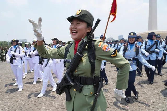 Women soldiers dance during a parade marking the 78th anniversary of the Indonesian Armed Forces in Jakarta, Indonesia, Thursday, October 5, 2023. (Photo by Tatan Syuflana/AP Photo)