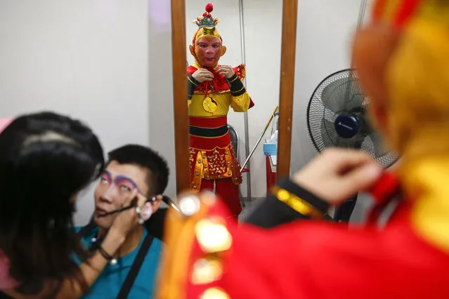 Members of a Chinese opera troupe prepare before a performance at a shopping mall ahead of the Chinese Lunar New Year celebrations in Bangkok, Thailand, February 4, 2016. (Photo by Athit Perawongmetha/Reuters)
