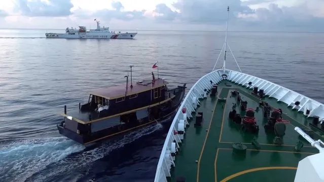 A Philippine flagged boat is blocked by a China Coast Guard vessel during an incident that resulted in a collision between the two vessels, in the disputed waters of the South China Sea in this screen grab obtained from handout video released on October 22, 2023. (Photo by China Coast Guard/Handout via Reuters)