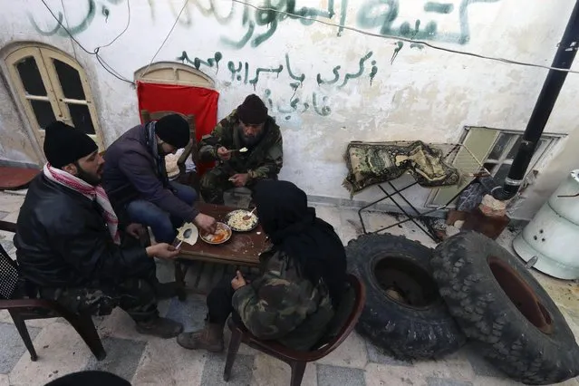 Free Syrian Army fighters eat their meal in Old Aleppo January 1, 2015. (Photo by Abdalrhman Ismail/Reuters)