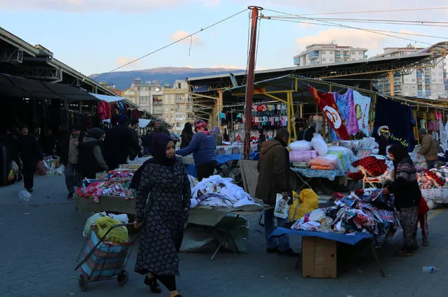 People shop at an open air market in the Aegean town of Soke, home town of Mevlut Mert Altintas, an off-duty police officer who gunned down the Russian Ambassador to Turkey Andrei Karlov at an art gallery in Ankara, in Aydin province, Turkey, December 21, 2016. (Photo by Hakan Akgun/Reuters)