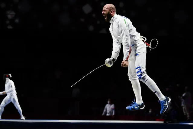 Italy's Andrea Santarelli celebrates scoring the winning point against Japan's Masaru Yamada in the men's epee individual quarter-final bout during the Tokyo 2020 Olympic Games at the Makuhari Messe Hall in Chiba City, Chiba Prefecture, Japan, on July 25, 2021. (Photo by Annegret Hilse/Reuters)