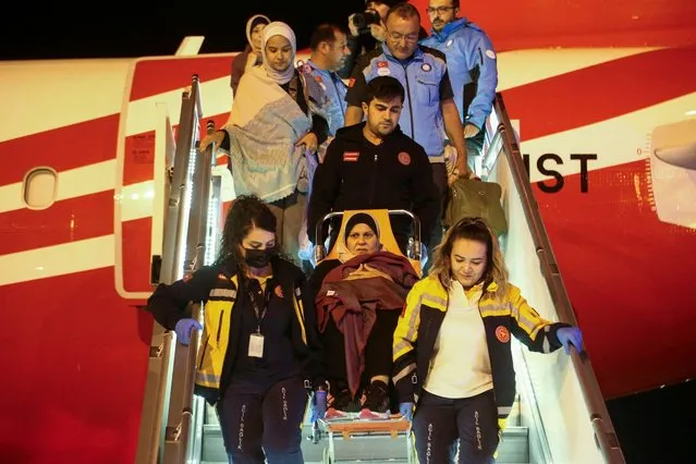 Medical staff carry a Palestinian cancer patient who was evacuated from Gaza to Egypt and brought to Turkey by plane, at Esenboga Airport in Ankara, Turkey on November 16, 2023. (Photo by Cagla Gurdogan/Reuters)