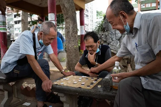 People play Chinese Chess at a park in Hong Kong's Yau Ma Tei area on July 31, 2021. (Photo by Bertha Wang/AFP Photo)
