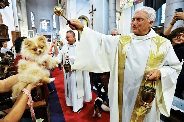 Father Gil Florini blesses a dog during a mass to honour Saint Francis of Assisi at the Saint Pierre D'Arene church in Nice, France on October 2, 2022. (Photo by Eric Gaillard/Reuters)