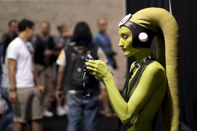 A woman in costume checks her phone at the Star Wars Celebration convention in Anaheim, California, April 16, 2015. The Star Wars Celebration runs through April 19 at the Anaheim Convention Center. (Photo by David McNew/Reuters)